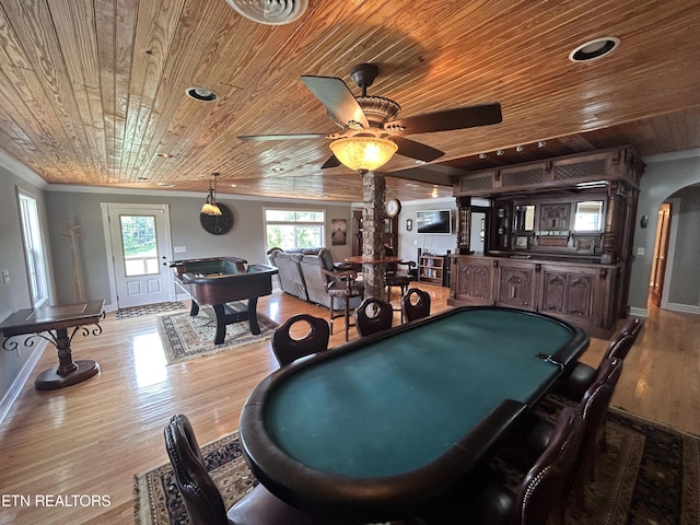 playroom with arched walkways, wood finished floors, wood ceiling, baseboards, and crown molding