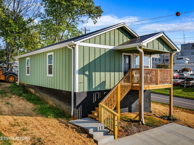 view of front of home with a standing seam roof, metal roof, and board and batten siding