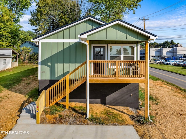 bungalow-style house featuring board and batten siding and a carport