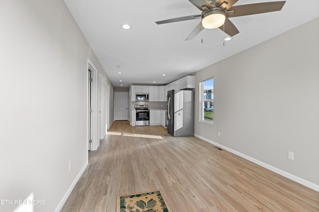 unfurnished living room with light wood finished floors, recessed lighting, a ceiling fan, and baseboards