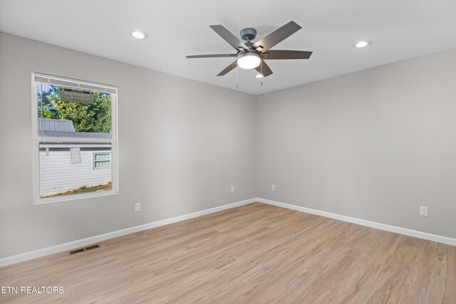 spare room with light hardwood / wood-style flooring and ceiling fan