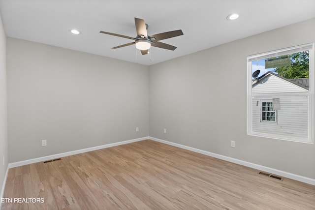 unfurnished room with baseboards, visible vents, light wood-style flooring, and recessed lighting