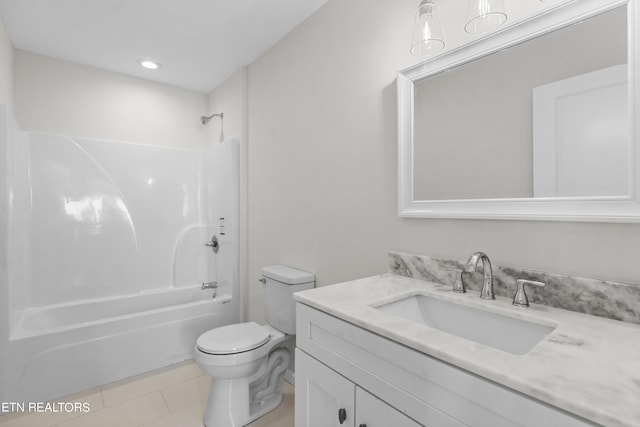 full bathroom featuring tile patterned floors, toilet,  shower combination, and vanity