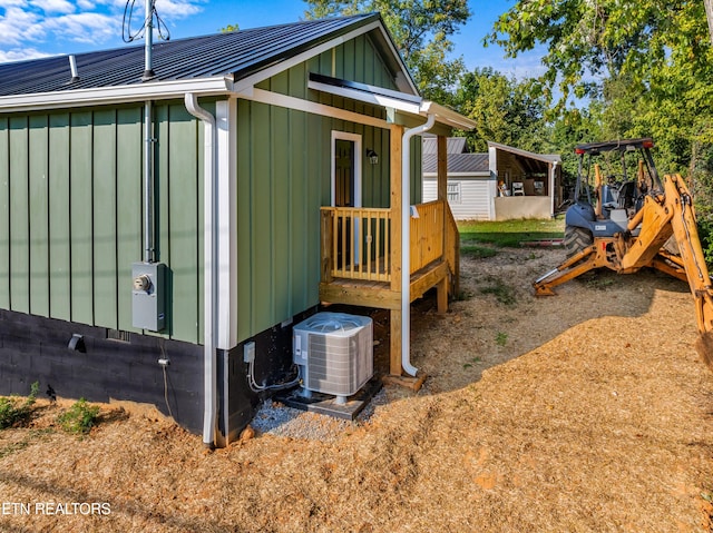 view of side of property featuring central AC and an outbuilding