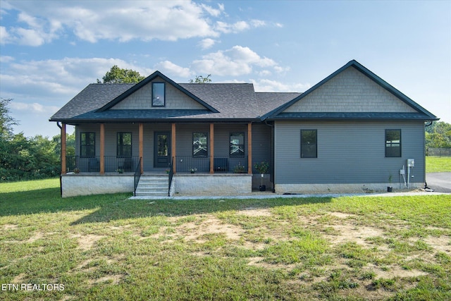 view of front of home featuring covered porch and a front yard