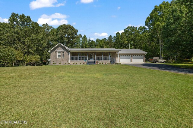 ranch-style house featuring a garage, a front yard, and a porch