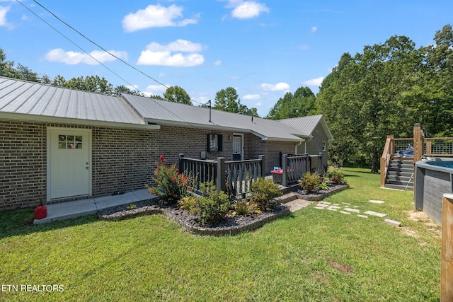 exterior space with a wooden deck and a yard