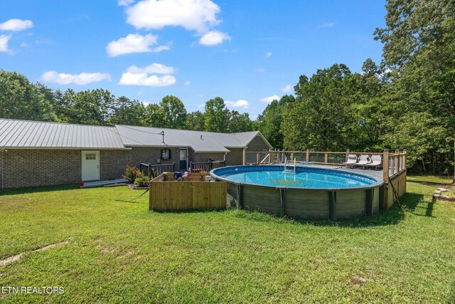 view of pool with a lawn