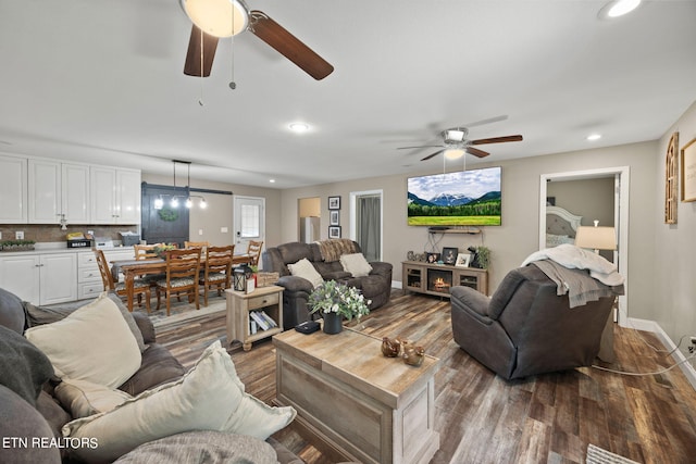 living room featuring hardwood / wood-style floors and ceiling fan