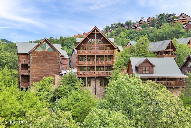 rear view of property featuring a balcony