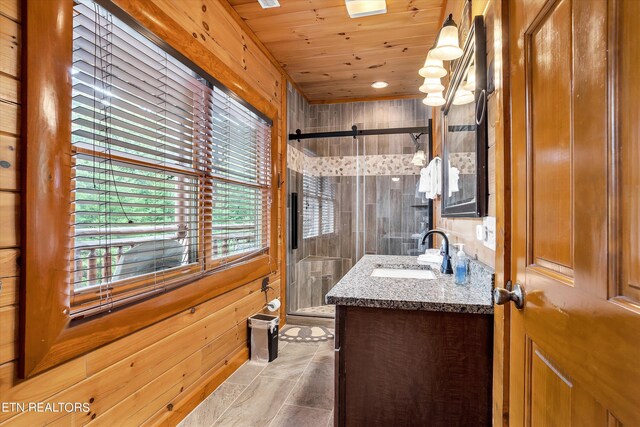 bathroom featuring tile patterned floors, tiled shower, wood ceiling, and vanity