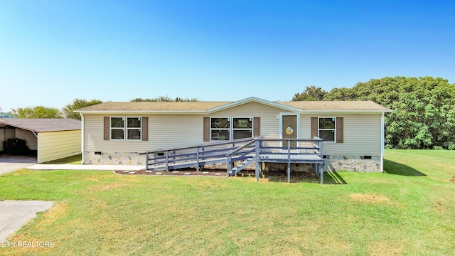 view of front of property with a front yard, a deck, and a carport