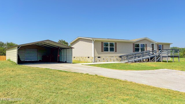 view of front of property featuring a deck, a garage, a front yard, and a carport