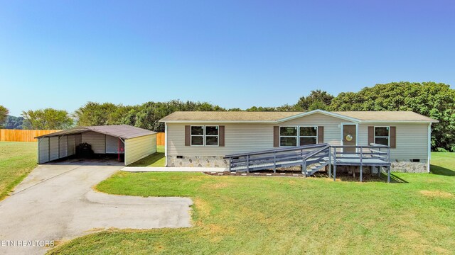 view of front facade with a front yard and a carport