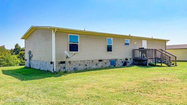 rear view of property with a lawn