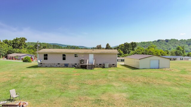 back of property featuring central air condition unit, a storage unit, and a lawn