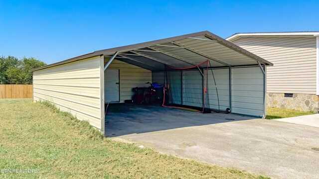 view of outdoor structure featuring a carport and a lawn