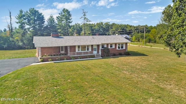 ranch-style house featuring a porch and a front lawn