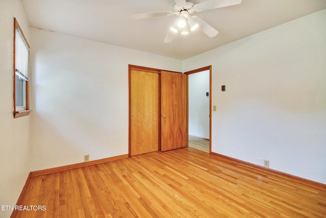 unfurnished bedroom with light wood-type flooring, a closet, and ceiling fan