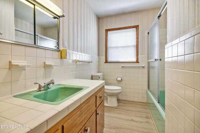 full bathroom with vanity, backsplash, tile walls, toilet, and hardwood / wood-style flooring