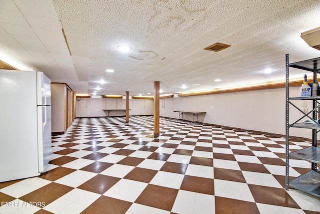 basement featuring white fridge