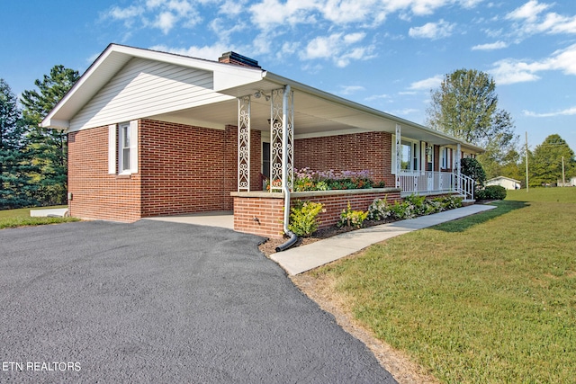 view of front of house with a porch and a front lawn