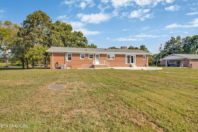 ranch-style house featuring a front lawn and cooling unit