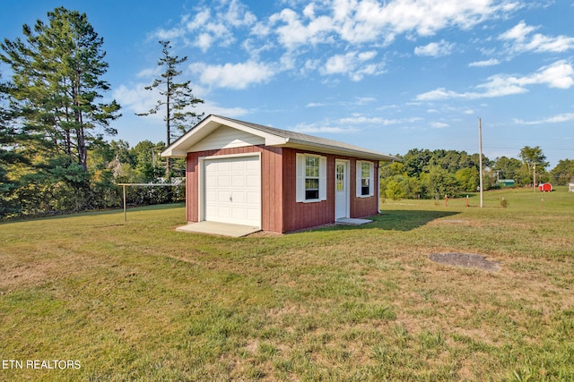 view of outbuilding with a yard and a garage