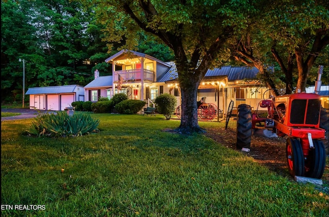 view of front of property with a balcony and a front lawn