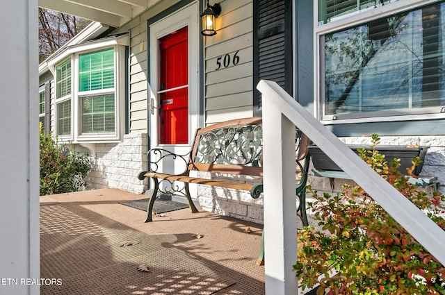 view of exterior entry featuring a porch