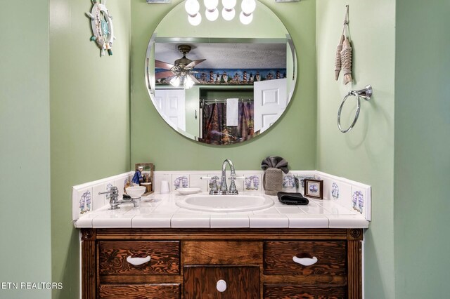 bathroom featuring ceiling fan and vanity