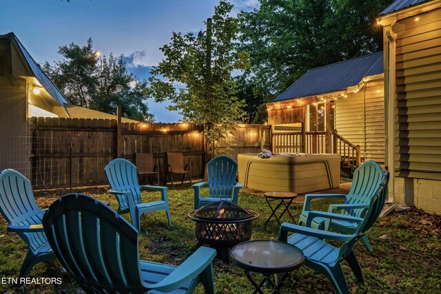 patio terrace at dusk featuring a fire pit