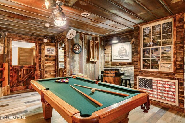 playroom with light hardwood / wood-style flooring, wood walls, pool table, and wooden ceiling