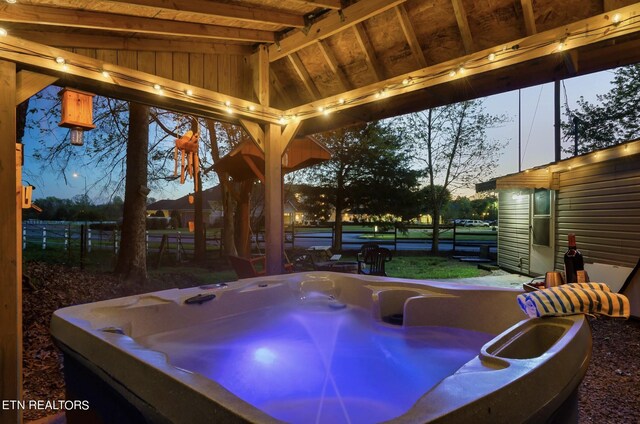 exterior space with a hot tub and a gazebo