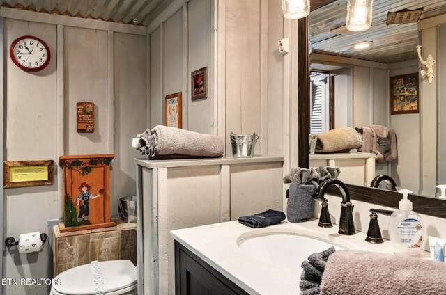 bathroom featuring vanity, toilet, and wooden ceiling