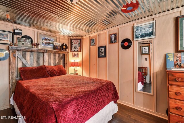 bedroom with dark wood-type flooring