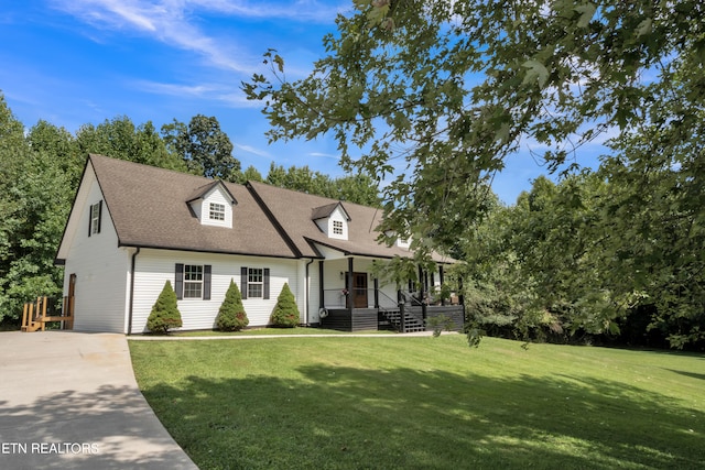 cape cod house with a porch and a front lawn