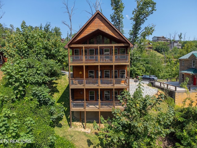 rear view of property featuring a balcony