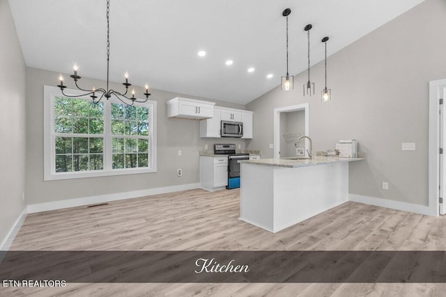 kitchen featuring light stone counters, appliances with stainless steel finishes, light hardwood / wood-style floors, and white cabinetry