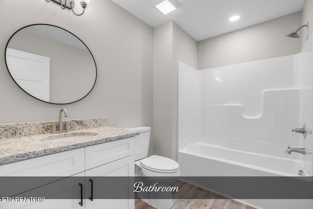 full bathroom with shower / bathing tub combination, vanity, toilet, and wood-type flooring