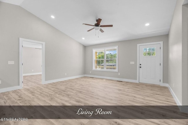 foyer entrance with ceiling fan, light hardwood / wood-style flooring, and vaulted ceiling