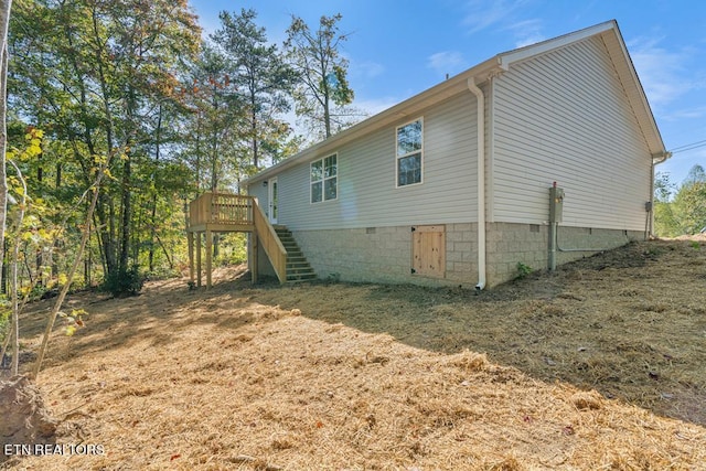 view of side of home featuring a deck