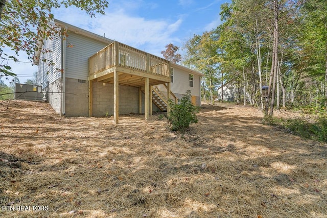 rear view of house with a wooden deck