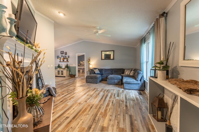 living room with crown molding, lofted ceiling, and hardwood / wood-style floors