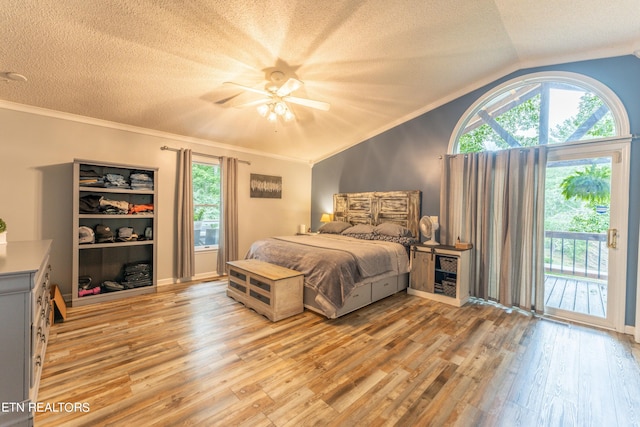 bedroom featuring ceiling fan, vaulted ceiling, light hardwood / wood-style floors, access to outside, and crown molding