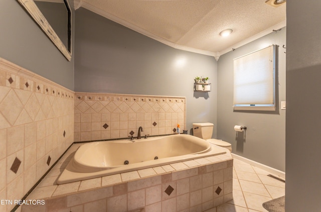 bathroom with a textured ceiling, tiled tub, tile patterned floors, toilet, and crown molding