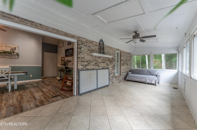 sunroom / solarium featuring ceiling fan