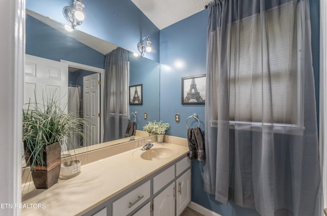 bathroom with a textured ceiling and vanity