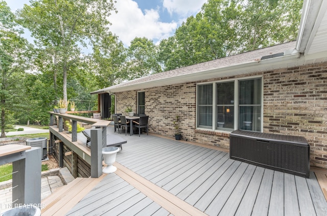 wooden deck featuring central AC unit