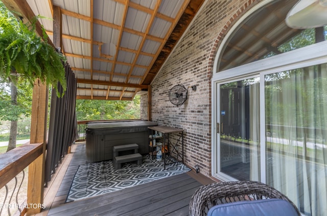 wooden terrace featuring a hot tub